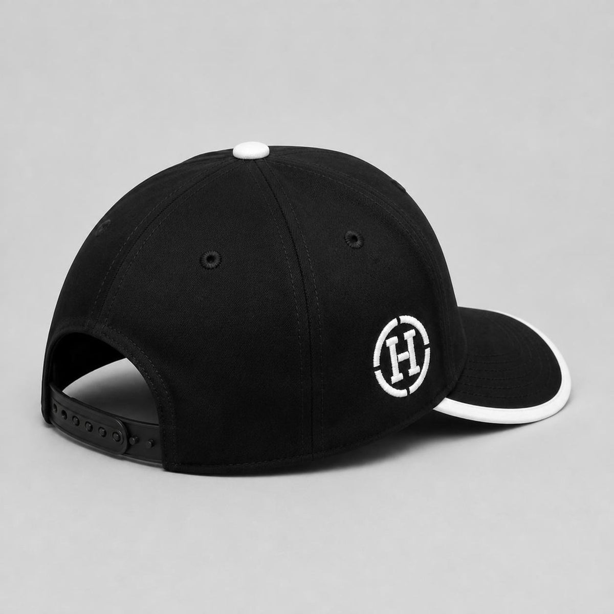 Black Six-Panel Cap with White Embroidered Circle Logo and Contrast Brim Trim