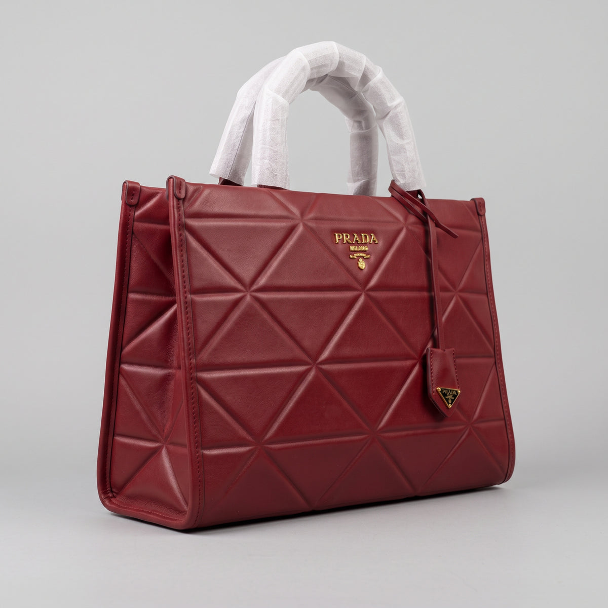 Women’s Burgundy Red Geometric Quilted Faux Leather Tote Bag with Gold Hardware and Hanging Charm