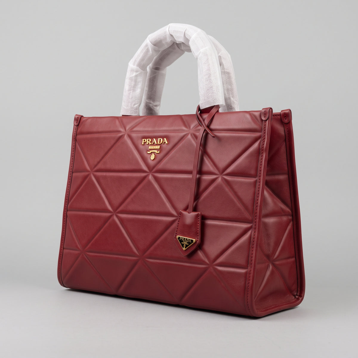 Women’s Burgundy Red Geometric Quilted Faux Leather Tote Bag with Gold Hardware and Hanging Charm